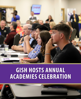  GISH students and community members listening to presenter at GISH Academies Celebration